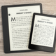 The Amazon Kindle Paperwhite sitting atop the Amazon Kindle Scribe, with both devices sitting on a wooden desk.